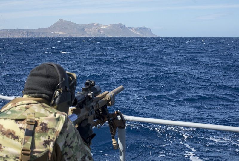 An Italian sniper engages a floating target from the bow of a Hellenic Navy vessel 14 March 2018, during unstable platform training held by the International Special Training Centre on the island of Crete, Greece. (Photo: US Army/1st Lt. Benjamin Haulenbeek)